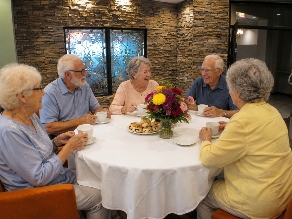 Residents enjoying coffee and conversation together around a table